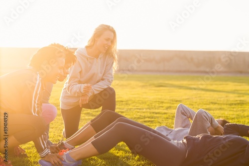 Sporty women doing sit ups during fitness class