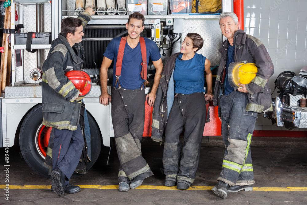 Fototapeta premium Confident Firefighters Leaning On Truck