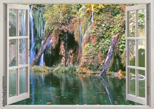 Open window view to deep forest waterfall with pond