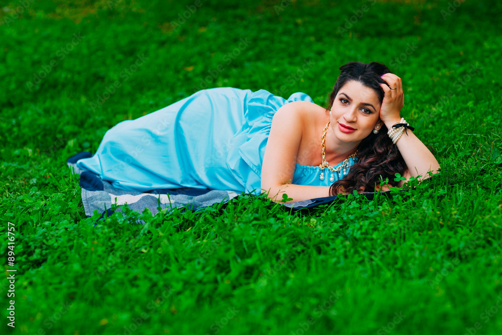 Beautiful pregnant woman relaxing outside in the park Beautiful pregnant woman relaxing outside in the park