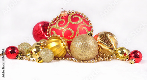 Golden and red Christmas decorations on a white