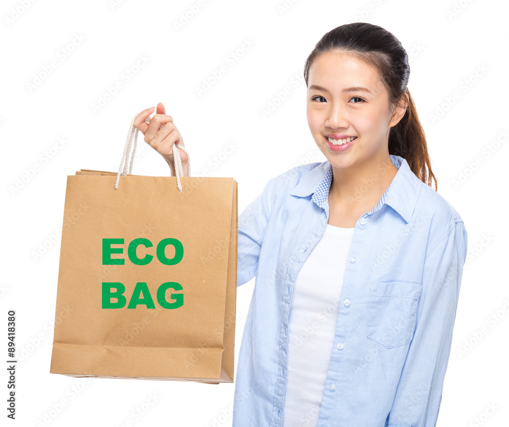 Young woman with shopping bag ans showing eco bag Young woman with shopping bag ans showing eco bag