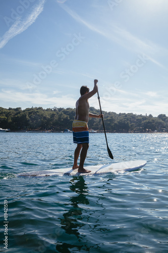 Young Man Paddleboarding