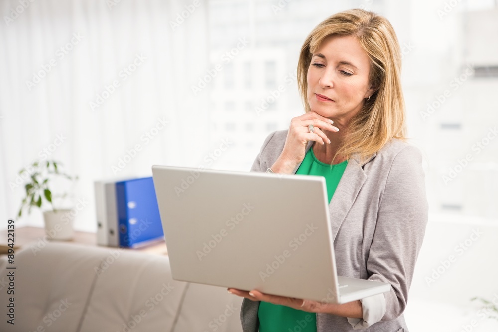 Concentrated casual businesswoman working with laptop Concentrated casual businesswoman working with laptop