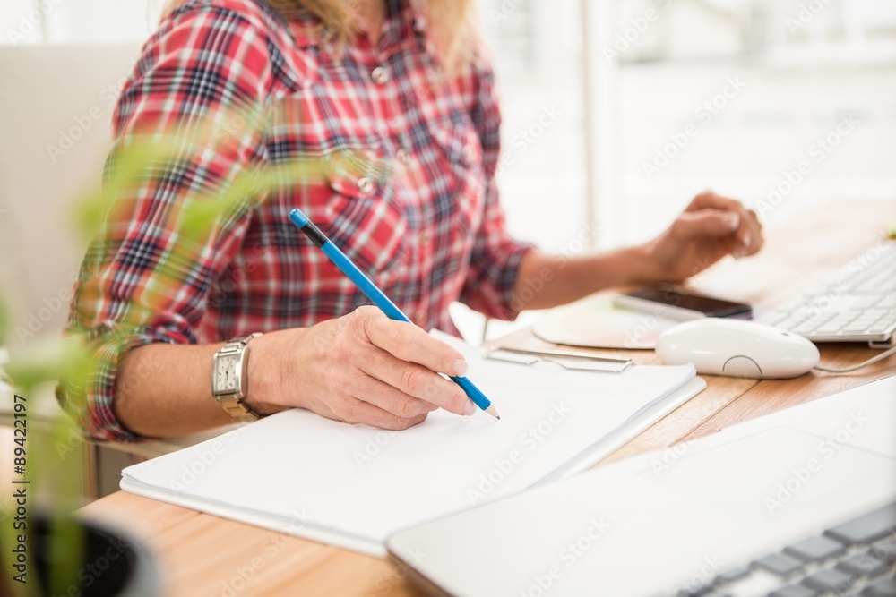 Casual designer designing on working desk