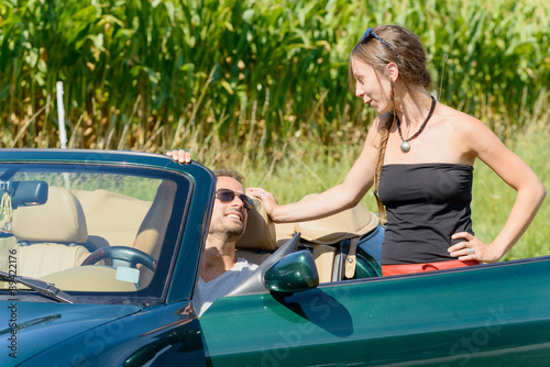 a young couple with convertible car