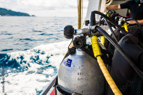 Scuba Diver equipment on boat with sea background