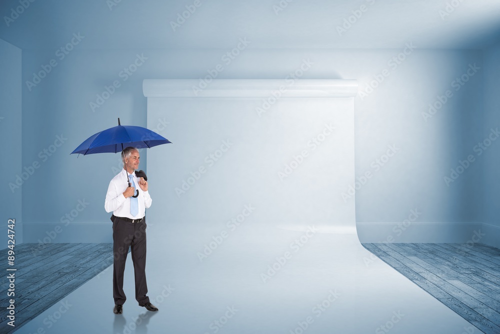 Composite image of happy businessman holding umbrella Composite image of happy businessman holding umbrella