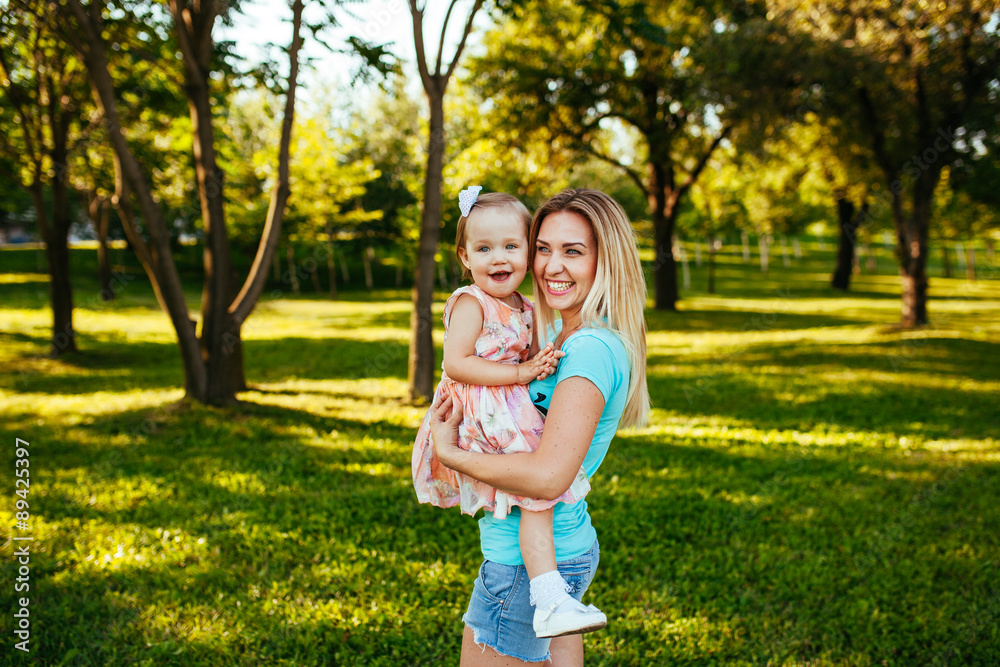 Fototapeta premium Happy mom and daughter smiling at nature.