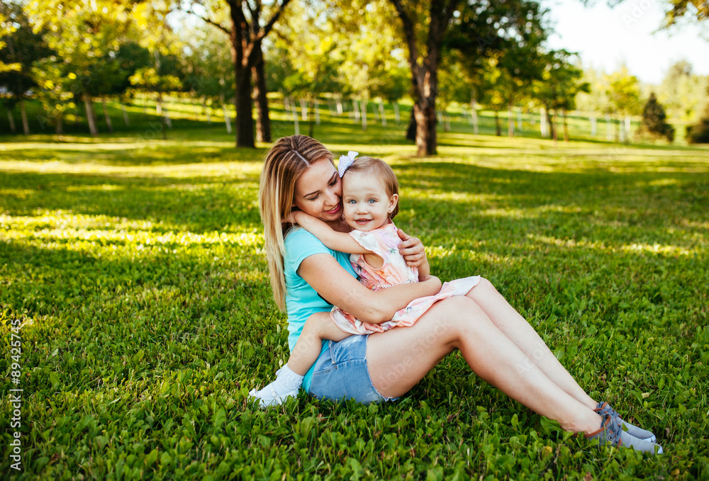 Fototapeta premium Happy mom and daughter smiling at nature.