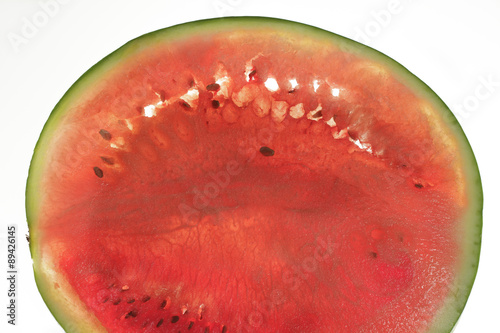 Top side of round watermelon slice, backlit photo