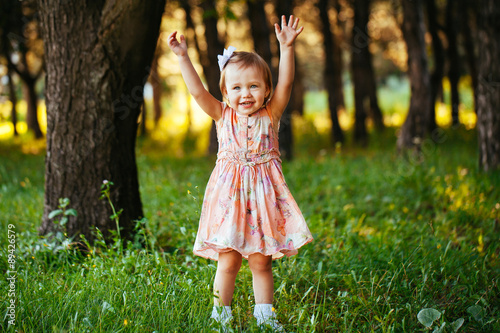 Cute little girl on the meadow in summer day. © davit85