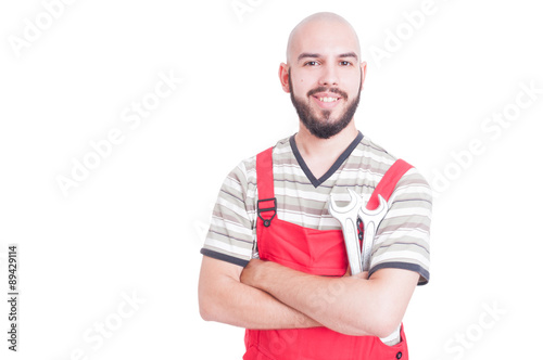 Friendly plumber or mechanic smiling and holding wrenches © Catalin Pop