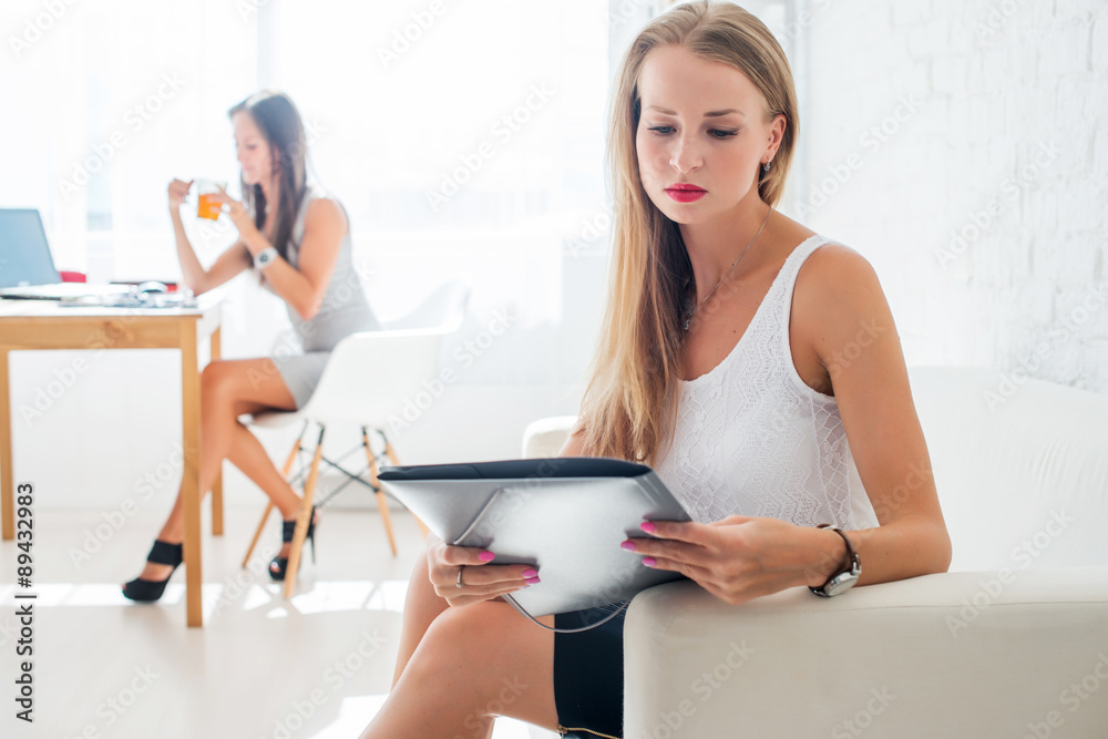portrait of business woman with folder sitting at office on sofa portrait of business woman with folder sitting at office on sofa