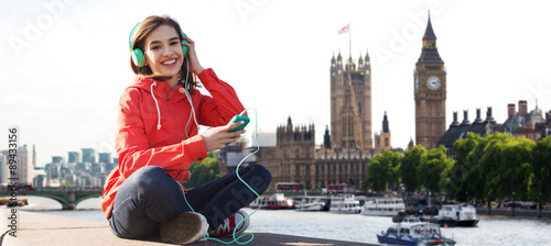 happy young woman with smartphone and headphones