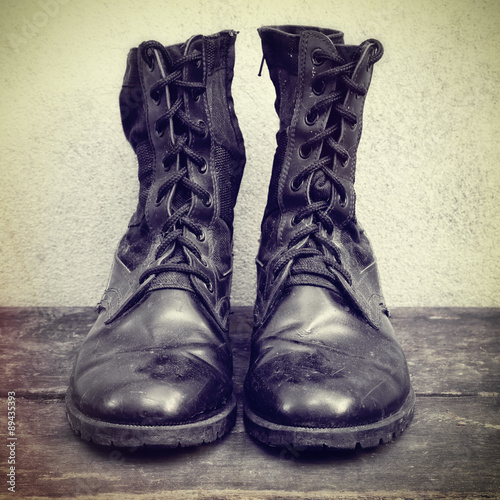 Old black boots on the wooden.