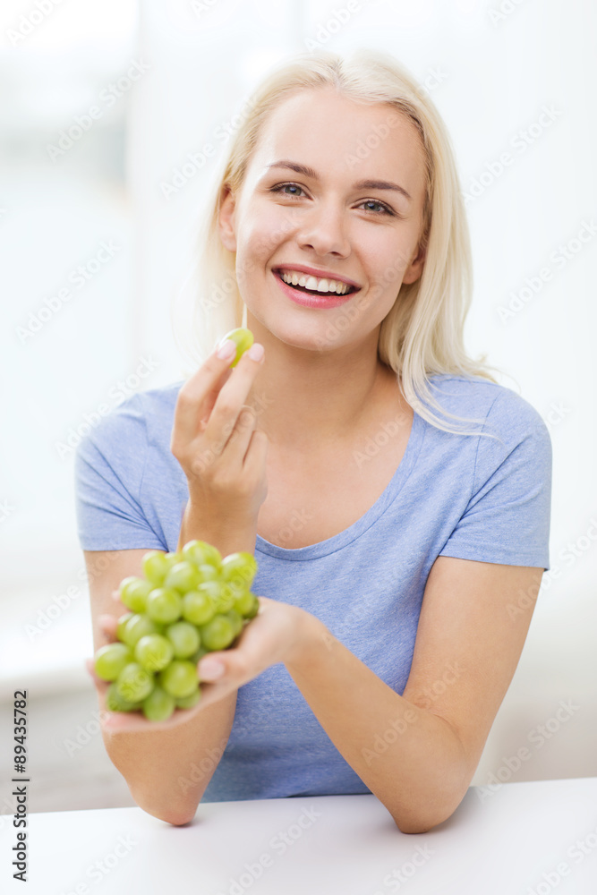 happy woman eating grapes at home happy woman eating grapes at home
