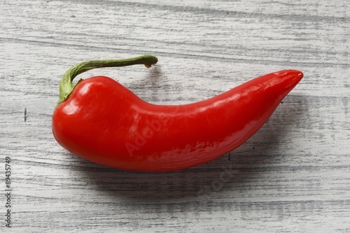 Fresh red chilli on wooden background (overhead view)