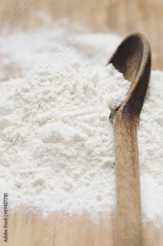 Flour with old wooden spoon