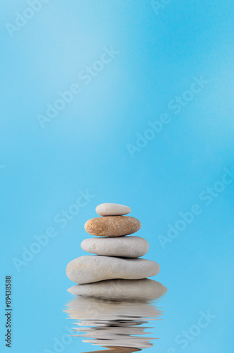 Stacking Stones on Watery Reflection with Blue Sky