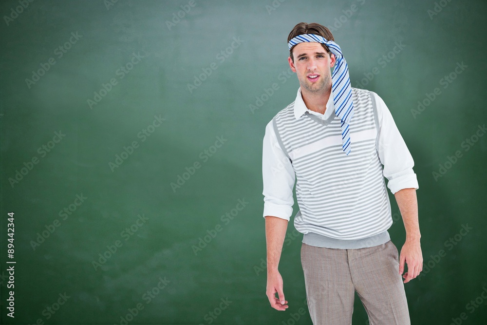 Composite image of geeky man with tie on his head 
