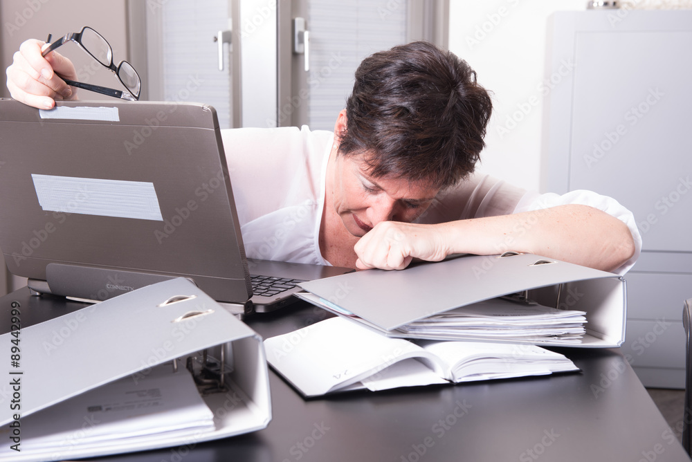 woman in her homeoffice is completely overworked woman in her homeoffice is completely overworked