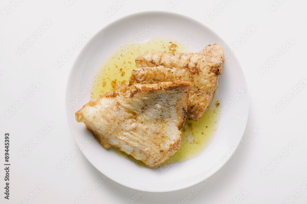 Fried fish fillets on plate