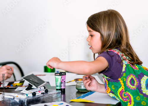 Wallpaper Mural Expressive portrait of a pretty young girl doing paint with her mum Torontodigital.ca