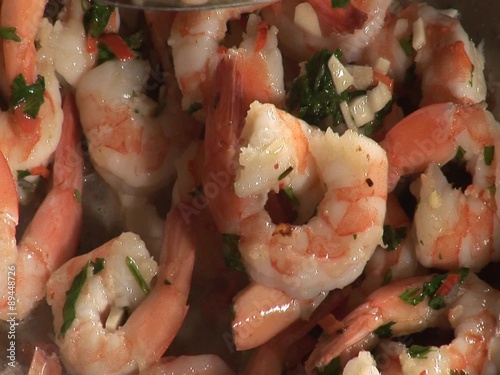 Prawns with garlic, chilli and herbs in a wok photo