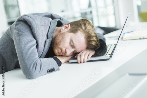 Tired young man sleeping in...