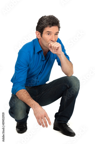 Handsome man doing different expressions in different sets of clothes: kneeling