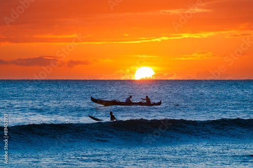 Boat and surfer at sunset, Maui, Hawaii, USA