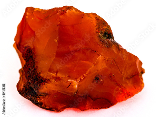 Rough red carnelian rock isolated on white background photo