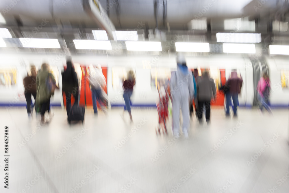 People standing and waiting in subway station, motion blur, zoom