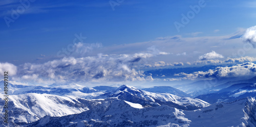 Panoramic view on sunlight snowy mountains