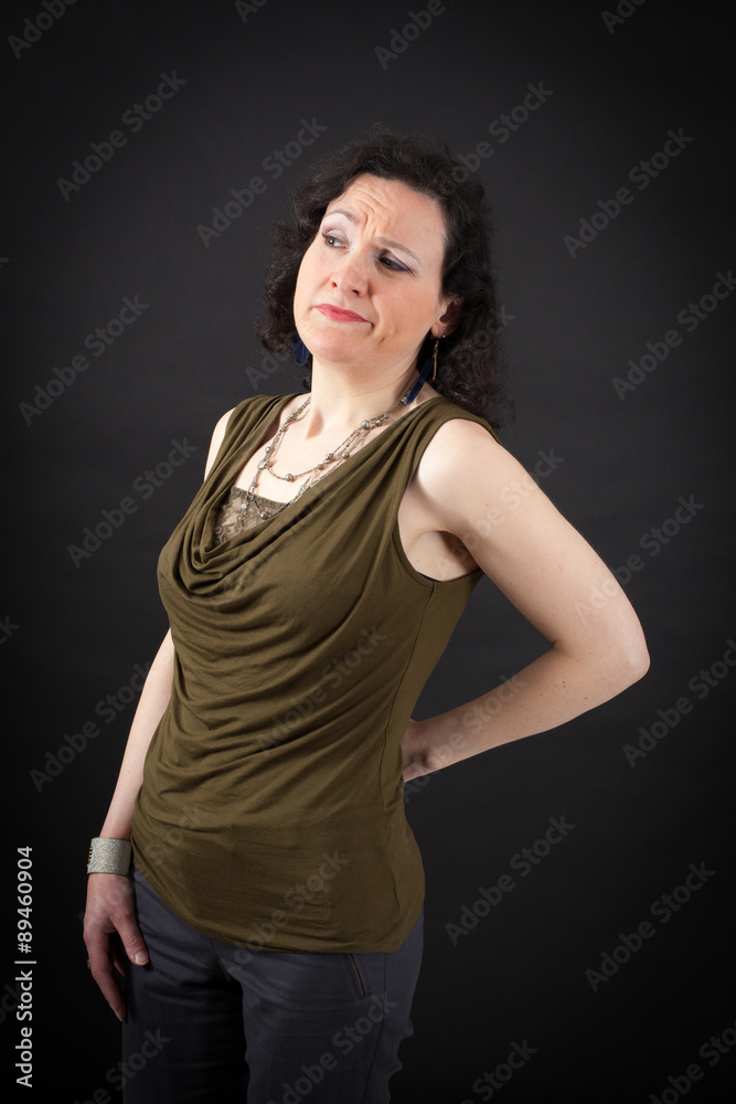 Beautiful woman doing different expressions in different sets of clothes: backache Beautiful woman doing different expressions in different sets of clothes: backache