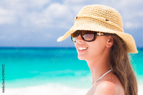 closeup back view of young woman in straw hat at tropical