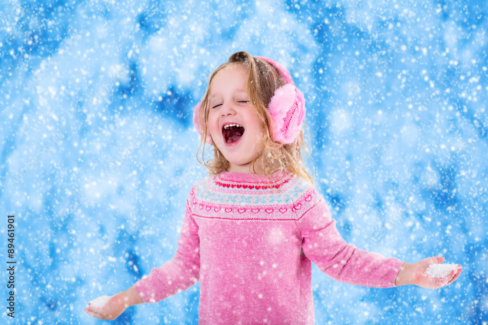 Little girl catching snow flakes Little girl catching snow flakes