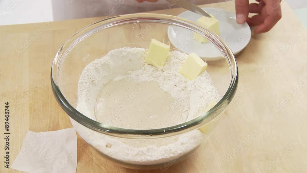 Butter pieces being placed around the starter dough Butter pieces being placed around the starter dough