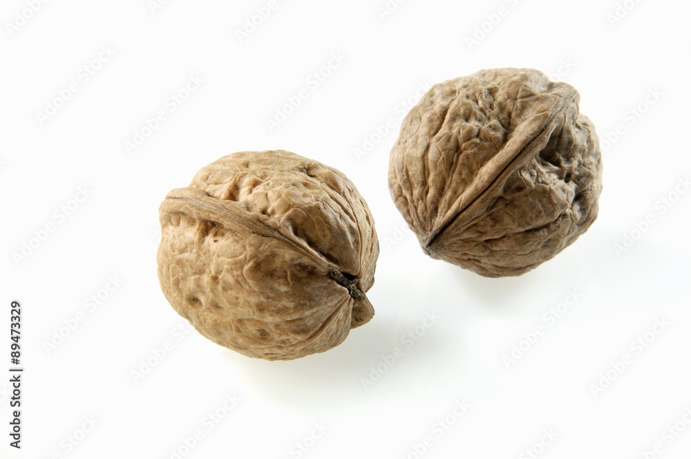Two unshelled walnuts Two unshelled walnuts