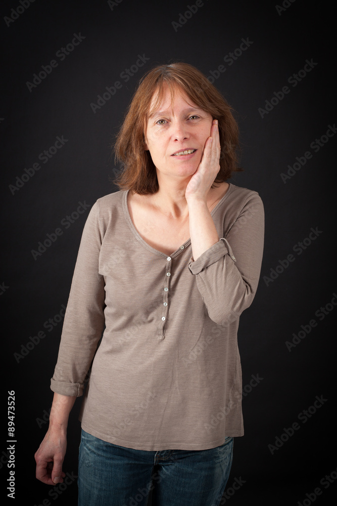 Beautiful woman doing different expressions in different sets of clothes: toothache Beautiful woman doing different expressions in different sets of clothes: toothache