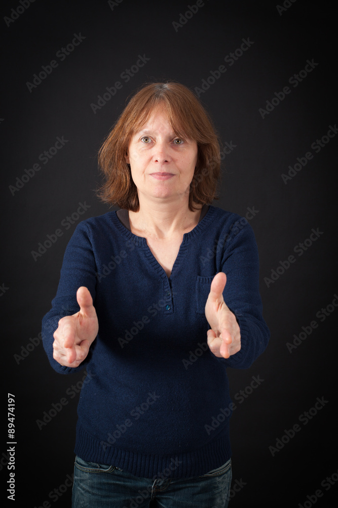 Beautiful woman doing different expressions in different sets of clothes: gun sign Beautiful woman doing different expressions in different sets of clothes: gun sign