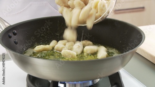 Gnocci being added to a pan of melted butter and sage