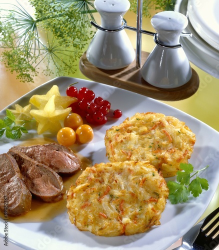 Fried duck breast with red wine sauce and ham rösti photo