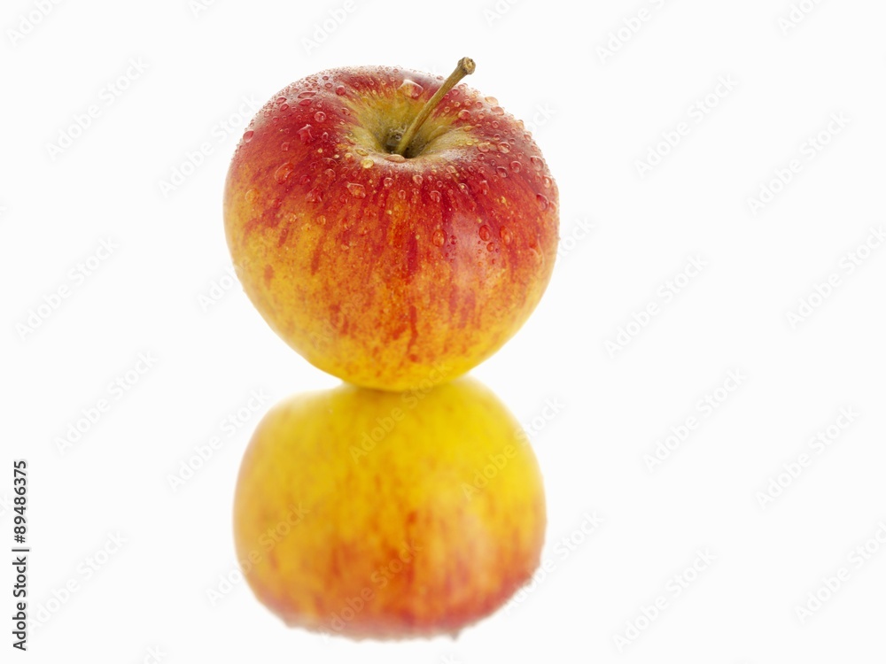A freshly washed red apple and its reflection A freshly washed red apple and its reflection