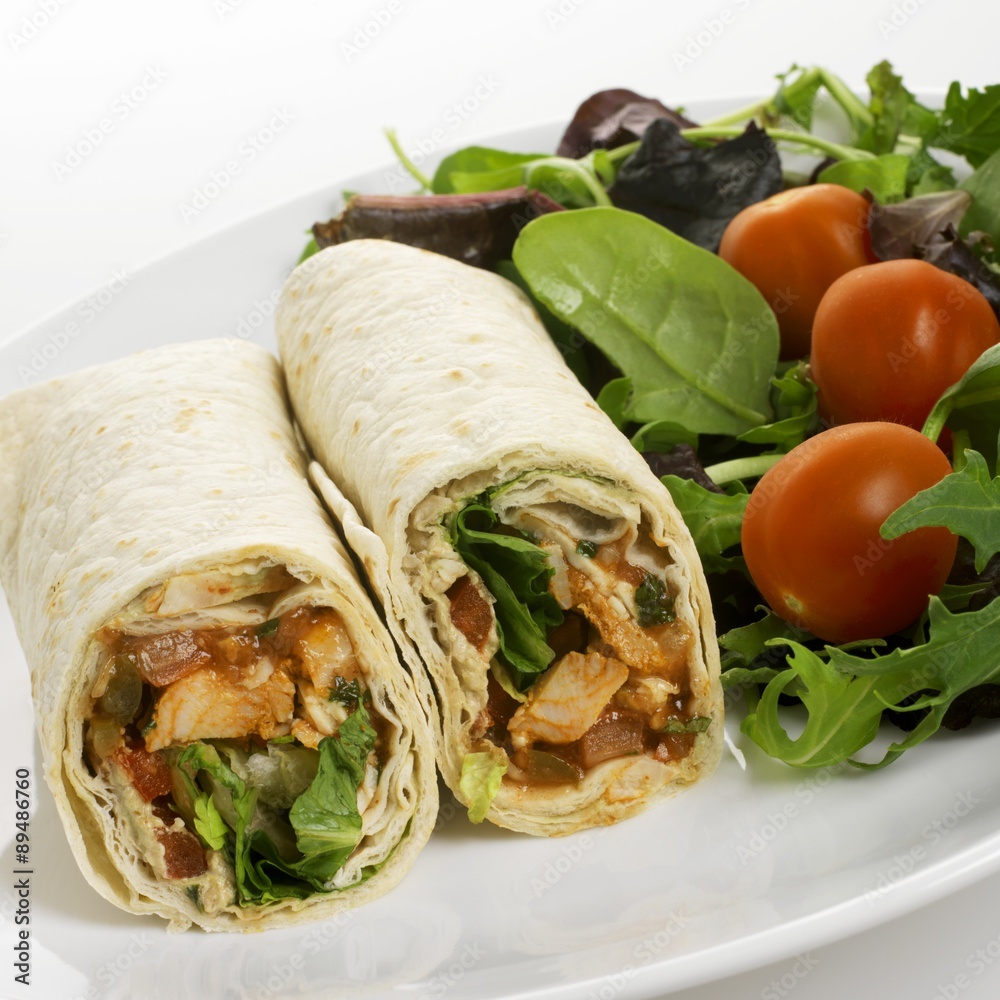 Chicken and tomato wrap with salad on a plate Chicken and tomato wrap with salad on a plate
