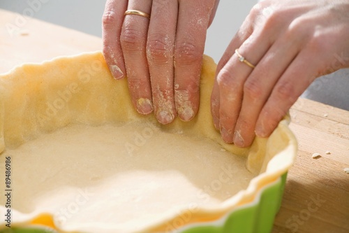 Making apple pie: lining a pie dish with shortcrust pastry