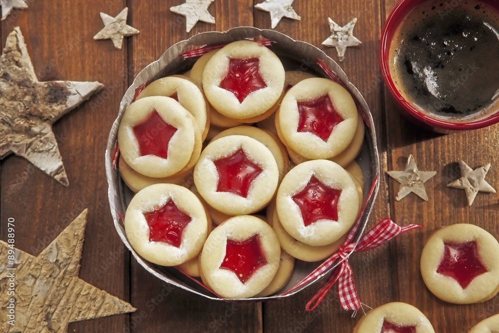 Shortbread jam-filled biscuits in a biscuit tin (seen from above) Shortbread jam-filled biscuits in a biscuit tin (seen from above)