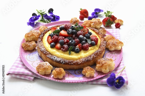 A puff pastry cake with vanilla cream and berries photo