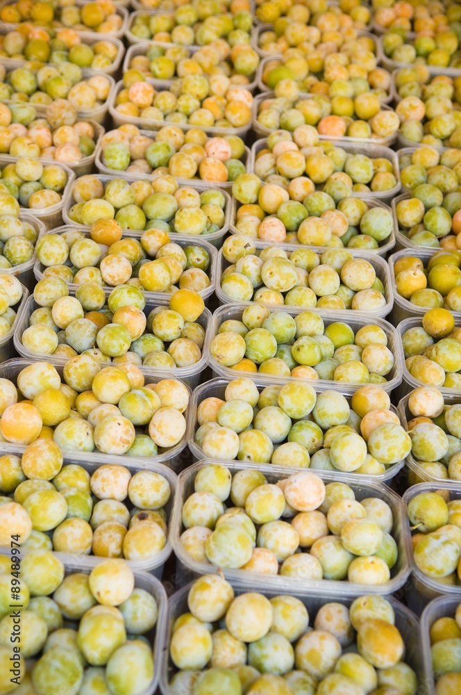 Yellow plums in plastic punnets Yellow plums in plastic punnets